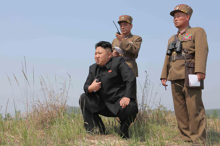 FILE PHOTO: North Korean leader Kim Jong Un (C) guides the multiple-rocket launching drill of women's sub-units under KPA Unit 851, in this undated photo released by North Korea's Korean Central News Agency (KCNA) April 24, 2014. KCNA via REUTERS/File Photo