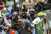 A protester prepares to throw a part of banana towards the police during a protest against the military coup in Yangon, Myanmar, Tuesday, March 2, 2021. Demonstrators in Myanmar took to the streets again on Tuesday to protest last month's seizure of power by the military, as foreign ministers from Southeast Asian countries prepared to meet to discuss the political crisis. Police in Yangon, Myanmar's biggest city, used tear gas against the protesters. (AP Photo)
