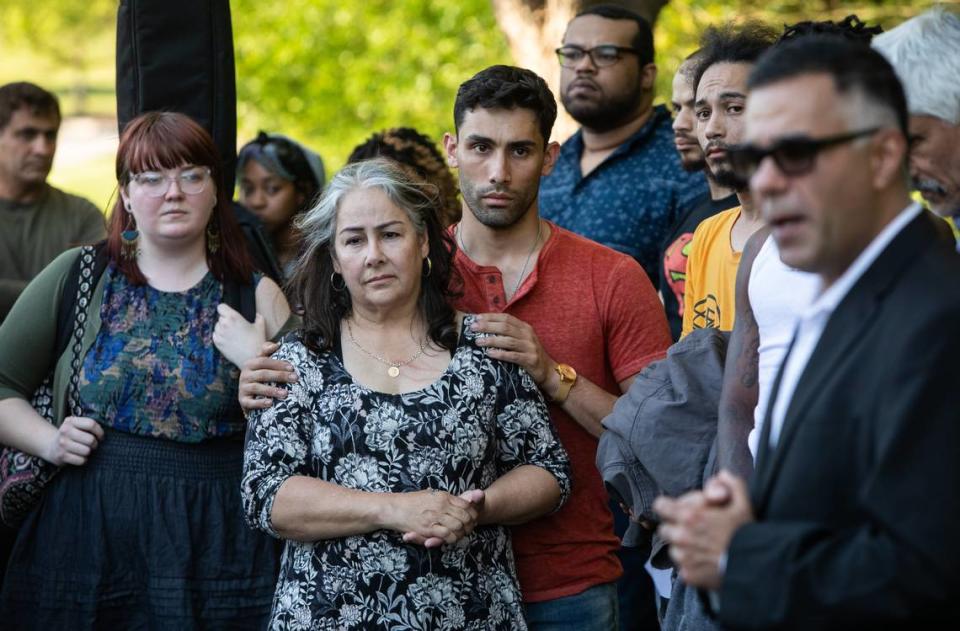 Siavash Mojarrad, the brother of Soheil Antonio Mojarrad, and their mother Judy Mojarrad, center, mourn for Soheil during a vigil at a shopping center off New Bern Avenue in Raleigh Tuesday, April 23, 2019. Soheil Mojarrad was killed in an officer-involved shooting Saturday.