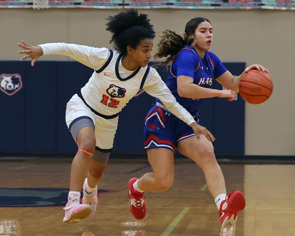 Glenn guard Mariah Houston (12) looks to steal from Hays point guard Jivana Caceres (11) during district play Dec. 19, 2023 at Glenn High School. Glenn turned up the heat in the fourth period to win 58-35.