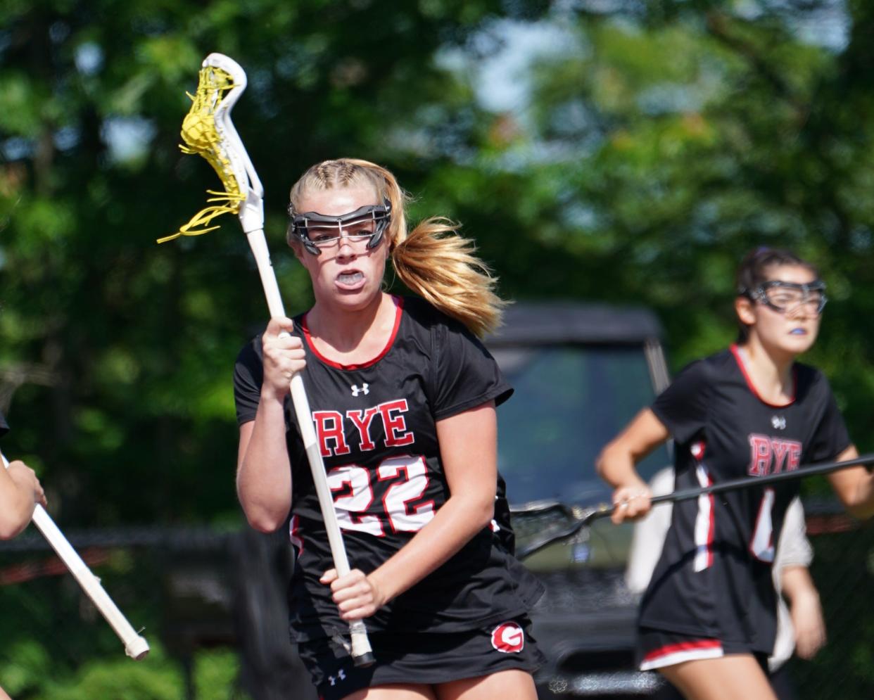 Rye's Lilly Whaling (22) controls the ball during the girls lacrosse Section 1 Class C championship game against John Jay-Cross River at Nyack High School in Nyack on Friday, May 26, 2023.