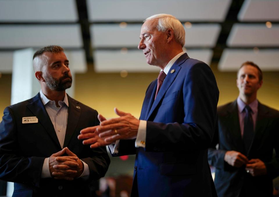 Republican presidential candidate and former Arkansas Gov. Asa Hutchinson, right, speaks with Billy Wilson, of the Iowa Firearms Coalition, at the Iowa Faith & Freedom Coalition's fall banquet, Saturday, Sept. 16, 2023, in Des Moines, Iowa. (AP Photo/Bryon Houlgrave)