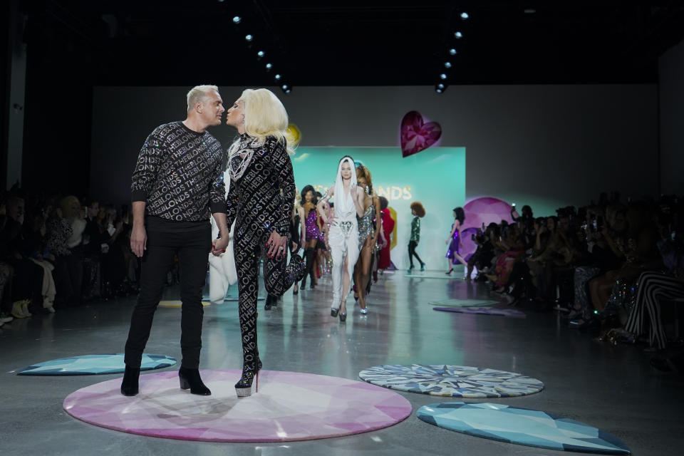 The Blonds designers David Blond, left, and Phillipe Blond kiss on the runway after their collection was presented during Fashion Week, Wednesday, Feb. 15, 2023, in New York. (AP Photo/Mary Altaffer)