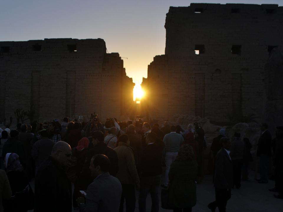 The sun peers through two massive walls that line the Temple of Karnak during the alignment of the winter solstice sunrise to the temple in the southern Egyptian city of Luxor on December 20, 2014.