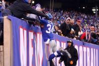 Dec 20, 2015; East Rutherford, NJ, USA; New York Giants running back Shane Vereen (34) jumps into the stands after scoring a touchdown against the Carolina Panthers during the fourth quarter at MetLife Stadium. Mandatory Credit: Brad Penner-USA TODAY Sports