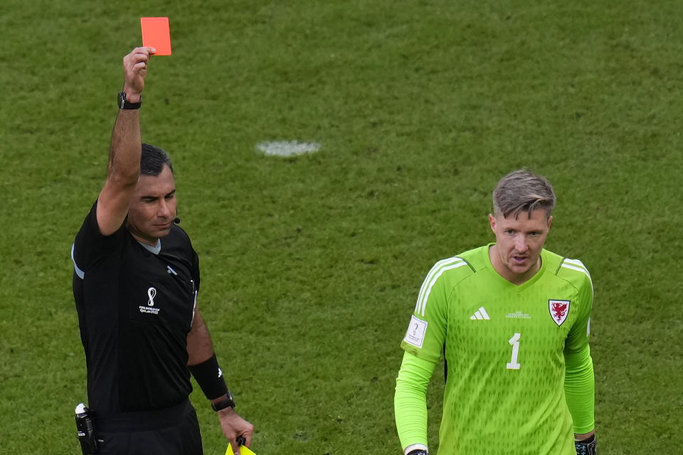 Referee Mario Alberto Escobar Toca shows a red card to Wales' goalkeeper Wayne Hennessey during the World Cup group B soccer match between Wales and Iran, at the Ahmad Bin Ali Stadium in Al Rayyan , Qatar, Friday, Nov. 25, 2022. (AP Photo/Manu Fernandez)