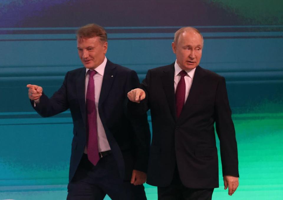 Russian President Vladimir Putin (R) and Sberbank CEO German Gref (L) point during the AIJ 2022 (Artifical Intelligence Journey) Conference on Nov. 24, 2022, in Moscow, Russia. (Contributor/Getty Images)