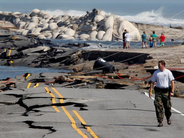 National Park Service Ranger Jeff Goad views the destruction to North Carolina Hwy 12 on the north edge of Rodanthe
