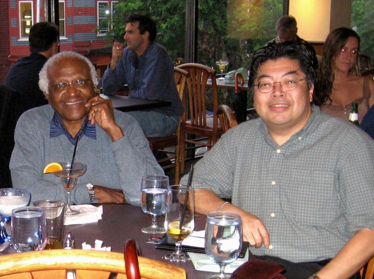 The late Archbishop Desmond Tutu and Norwell resident Stewart Ting Chong, shown at a restaurant in Harvard Square, worked together to stop apartheid.  Ting Chong will give a talk about experiences and friendship with the archbishop Oct. 27 in Duxbury.