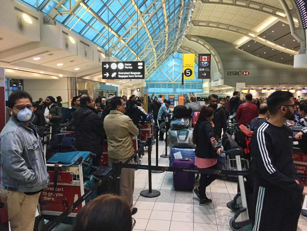 Crowd of passengers waiting to check-in for their flight at Pearson International Airport in Ontario, Canada. Some passangers are wearing masks to protect from the novel coronavirus (COVID-19). Pearson International Airport is Canada's largest and busiest airport. (Photo by Creative Touch Imaging Ltd./NurPhoto via Getty Images)