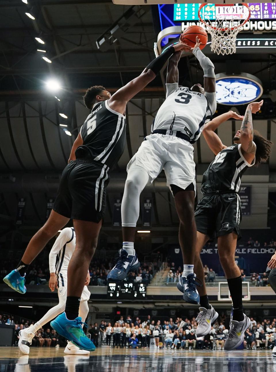 Friars forward Ed Croswell blocks a shot attempt by Butler Bulldogs forward Chuck Harris during the second half on Thursday night in Indianapolis.