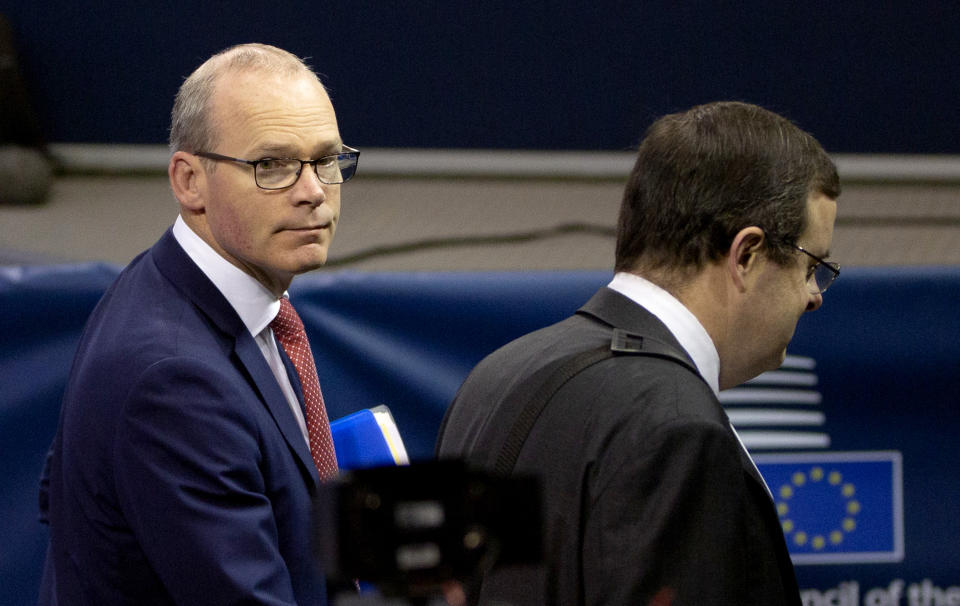 Irish Foreign Minister Simon Coveney, left, arrives for a meeting of EU foreign ministers at the European Convention Center in Luxembourg, Monday, Oct. 14, 2019. Ireland says that a Brexit deal may be possible in the coming days, after technical teams from Britain and the European Union worked through the weekend. (AP Photo/Virginia Mayo)