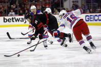 Carolina Hurricanes' Martin Necas (88) collides with New York Rangers' Vincent Trocheck (16) during the second period in Game 4 of an NHL hockey Stanley Cup second-round playoff series in Raleigh, N.C., Saturday, May 11, 2024. (AP Photo/Karl B DeBlaker)