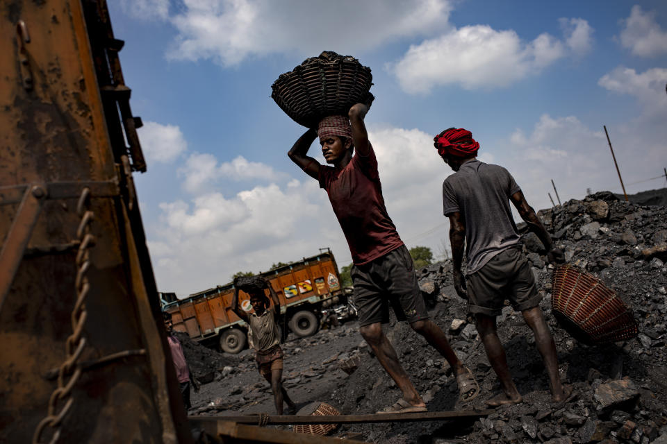 Laborers load coal onto trucks for transportation near Dhanbad, an eastern Indian city in Jharkhand state, Friday, Sept. 24, 2021. No country will see energy needs grow faster in coming decades than India, and even under the most optimistic projections part of that demand will have to be met with dirty coal power — a key source of heat-trapping carbon emissions. (AP Photo/Altaf Qadri)