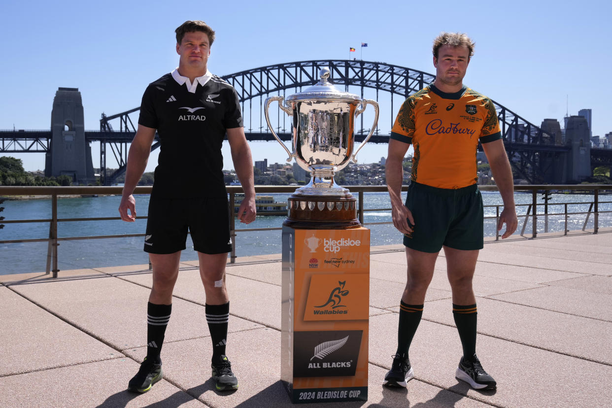 Australia captain Harry Wilson, right, and New Zealand skipper Scott Barrett, left, pose with the Bledisloe Cup in Sydney, Friday, Sept. 20, 2024, ahead of their rugby union test match Saturday. (AP Photo/Rick Rycroft)