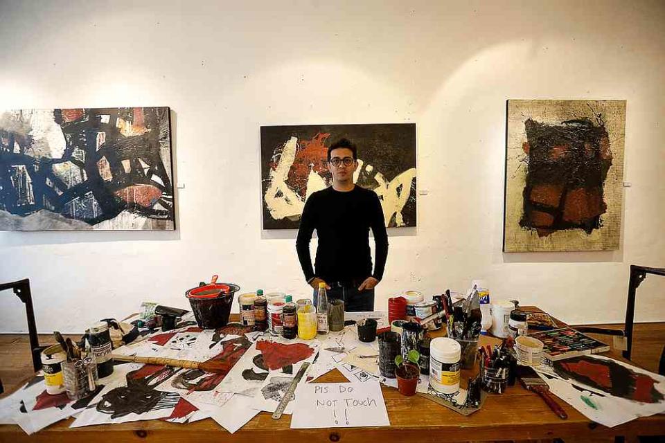 Syrian artist Alaa Shasheet with the installation piece that depicts his studio. — Picture by Sayuti Zainudin