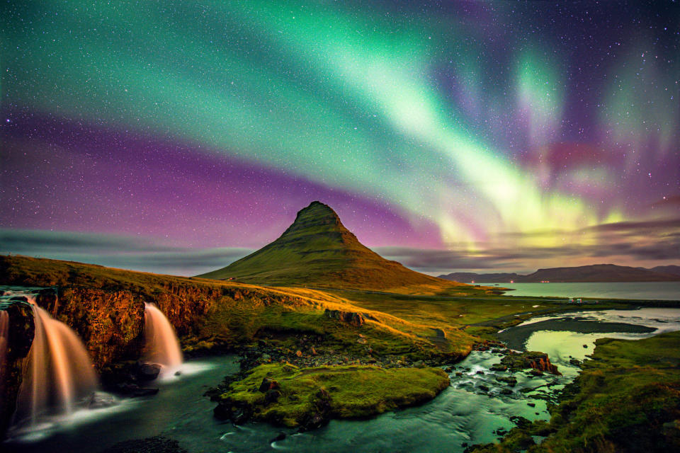 Northern lights over a rock formation.