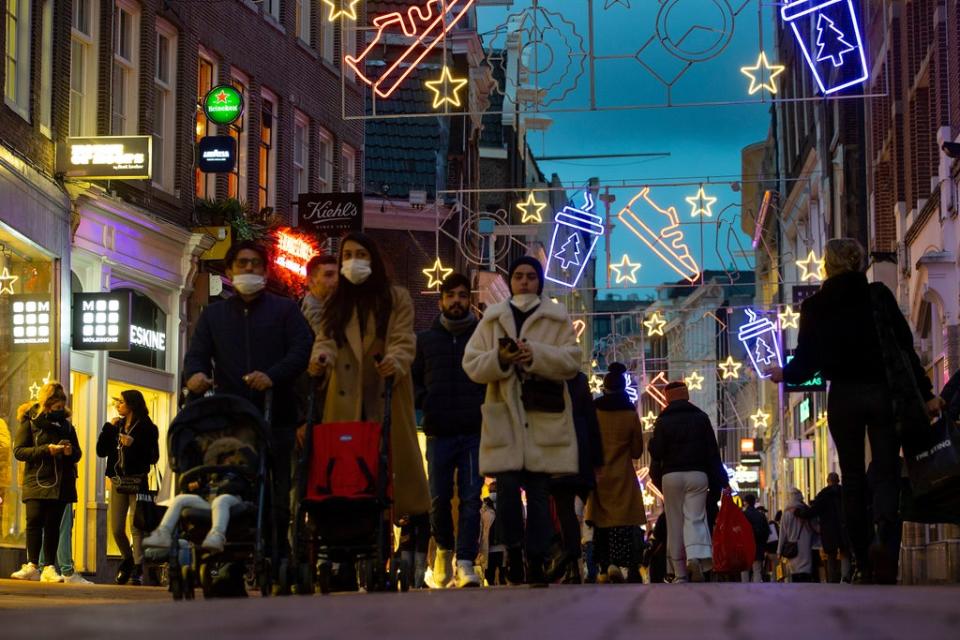 Shoppers walk down Kalverstraat in Amsterdam (AP)