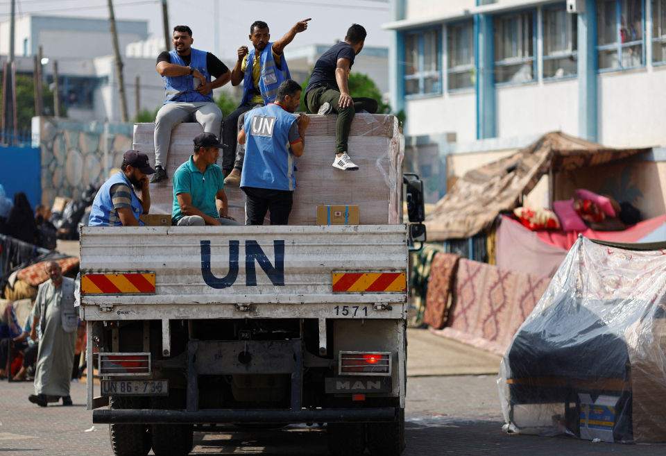 United Nations workers arrive to distribute aid to Palestinians (Reuters)