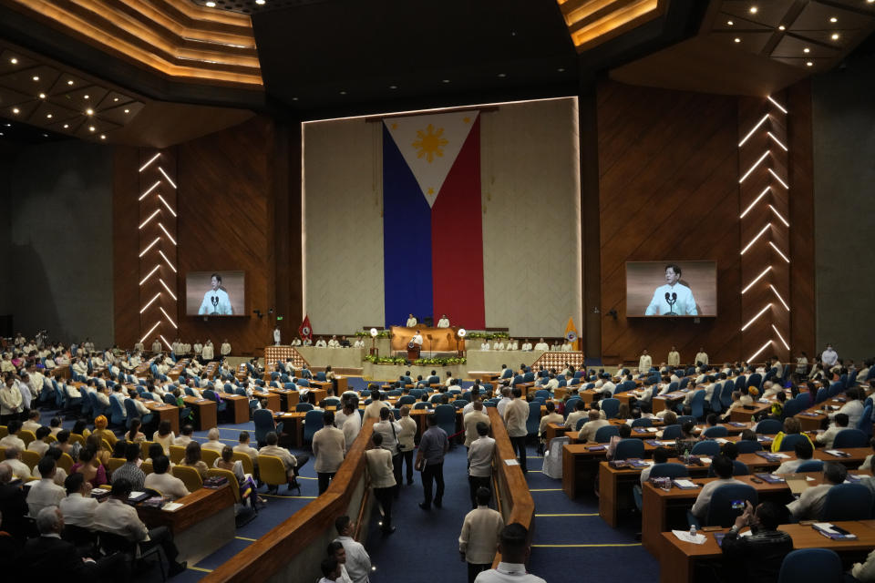 Philippine President Ferdinand Marcos Jr. is shown on an electronic board as he delivers his second state of the nation address at the House of Representatives in Quezon City, Philippines on Monday, July 24, 2023. (AP Photo/Aaron Favila)