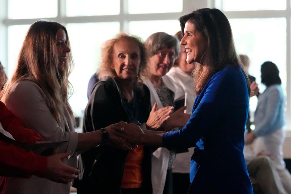 Republican presidential candidate Nikki Haley shakes hands with guests during a campaign gathering, Wednesday, May 24, 2023, in Bedford, N.H.