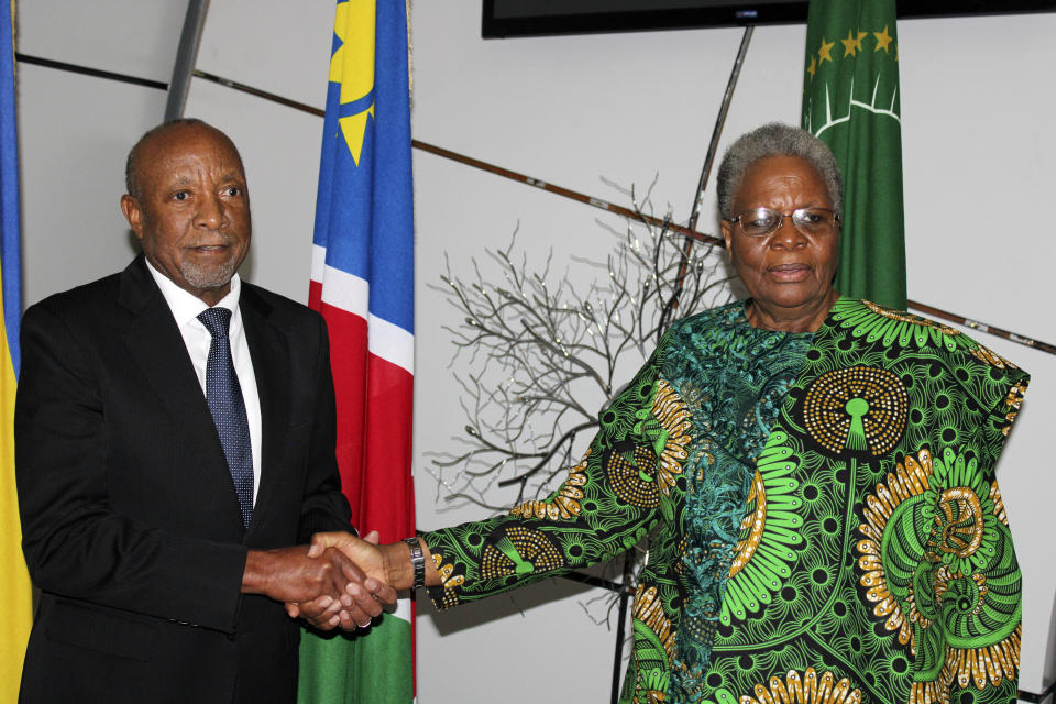 Newly sworn in Namibian acting president Nangolo Mbumba, left, shakes hands with Netumbo Nandi-Ndaitwa, his deputy, after taking the oath of office in the capital, Windhoek, Sunday, Feb, 4.2024.Namibia, one of Africa's most stable democracies, Sunday swore in a new leader hours after the death of the country's president Hage Geingob. Geingob died while receiving medical treatment at a local hospital, his office announced.(AP Photo/Ester Mbathera)