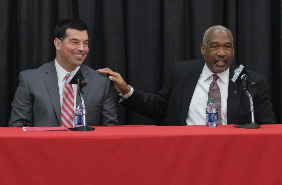 Ohio State athletics director Gene Smith pats offensive coordinator Ryan Day during a news conference announcing Urban Meyer's retirement and Day's hiring as head coach on Dec. 4, 2018.