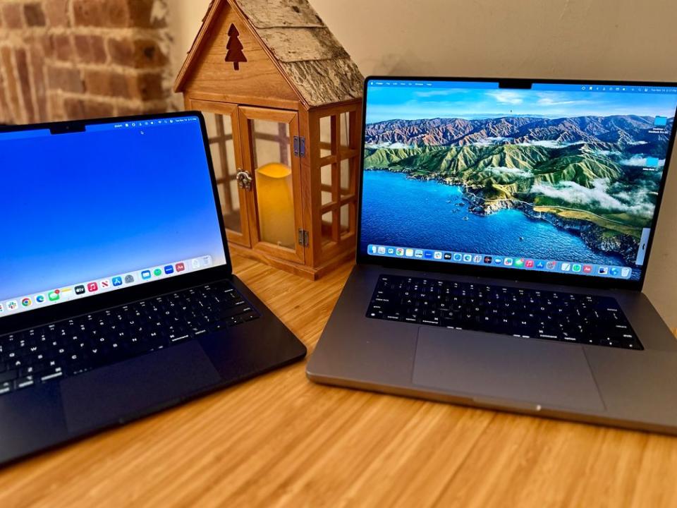 a couple of laptops sit on a table