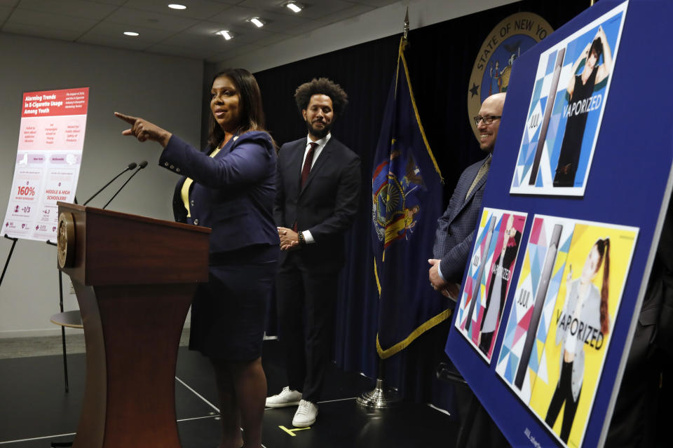 New York State Attorney General Letitia James speaks during a news conference at her office in New York, Tuesday, Nov. 19, 2019. New York has joined the ranks of states suing the nation's biggest e-cigarette maker, San Francisco based JUUL Labs. At background left and right are Andre Richardson, campaign manager of Flavors Hook Kids, and East Hampton High School Principal Adam Fine. (AP Photo/Richard Drew)