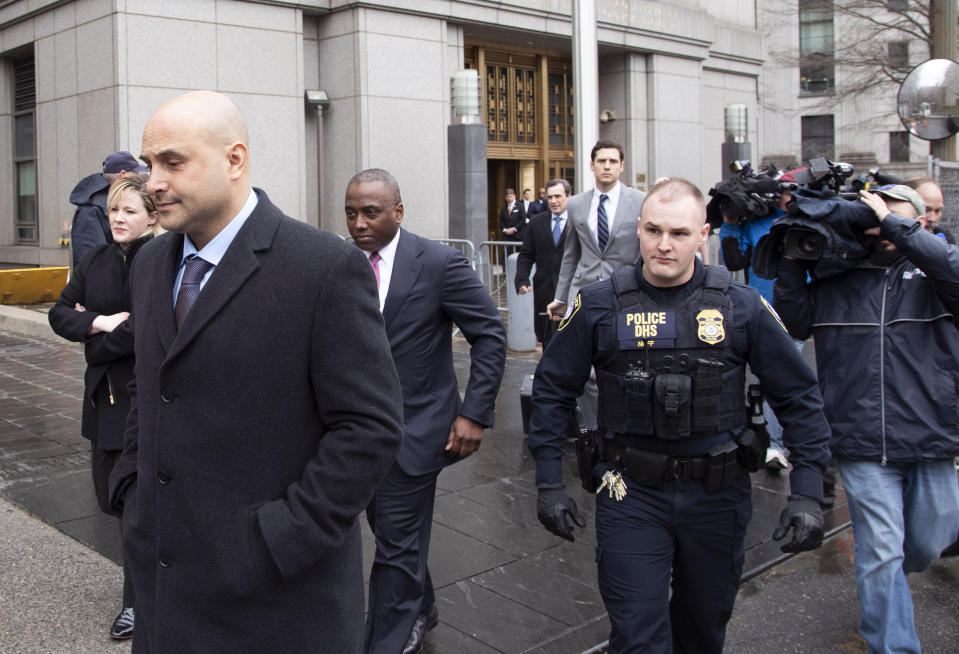 Craig Carton, left, the former co-host of a sports radio show with ex-NFL quarterback Boomer Esiason, leaves federal court after receiving a 3 1/2 year sentence for defrauding investors in a ticket reselling business, Friday, April 5, 2019, in New York. (AP Photo/Mark Lennihan)