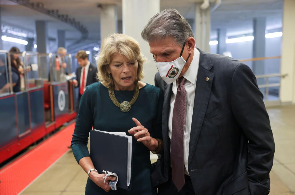 Sens. Lisa Murkowski, R-Alaska, and Joe Manchin, D-W.Va., walk together in the Senate subway at the U.S. Capitol. 