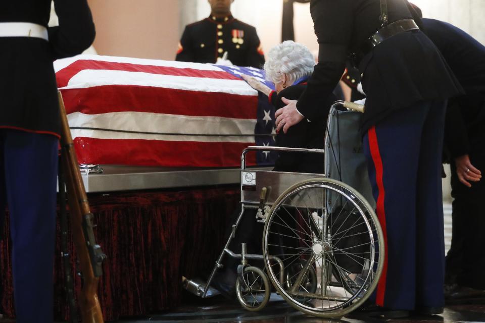 Annie Glenn rests her hand on her husband John Glenn's casket as he lies in honor, Friday, Dec. 16, 2016, in Columbus, Ohio. Glenn's home state and the nation began saying goodbye to the famed astronaut who died last week at the age of 95. (AP Photo/John Minchillo)