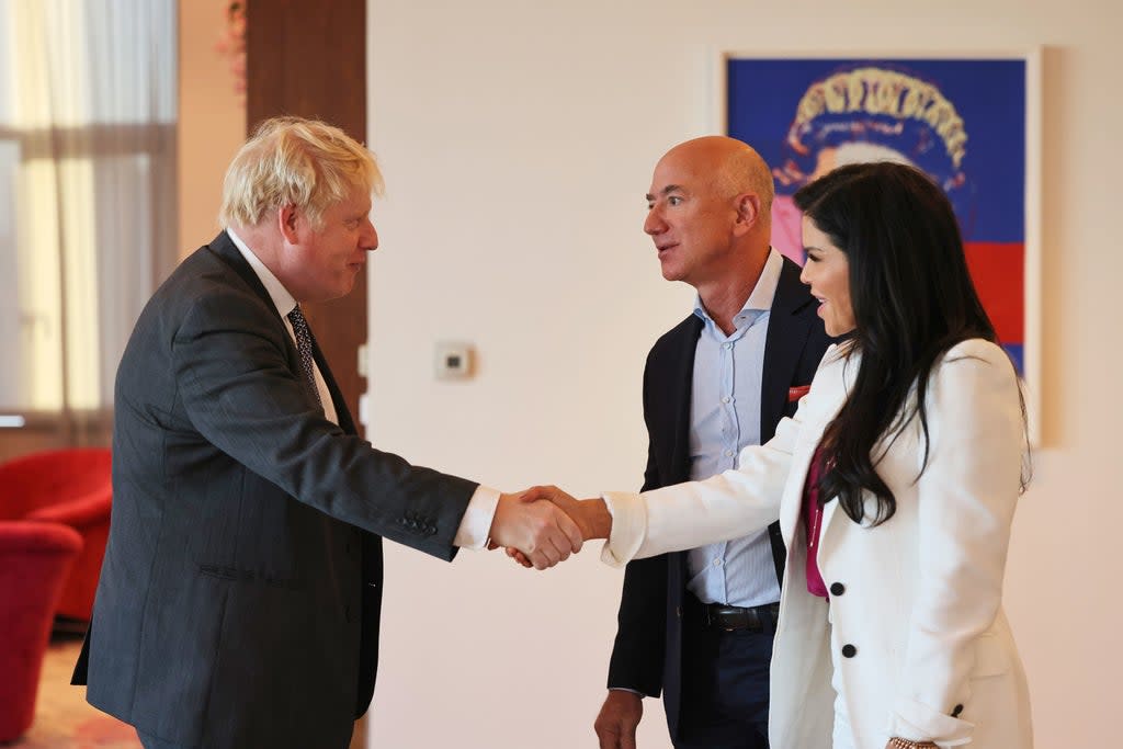 Prime Minister Boris Johnson greets Amazon founder Jeff Bezos and his girlfriend, Lauren Sanchez, at the UK diplomatic residence (PA)