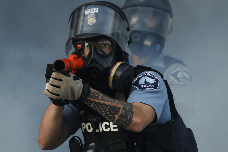 In this image released by World Press Photo, Thursday April 15, 2021, by John Minchillo, Associated Press, part of a series titled Minneapolis Unrest: The George Floyd Aftermath, which won third prize in the Spot News Stories category, shows Police fire tear gas on demonstrators at the intersection of East Lake Street and Hiawatha Avenue in St Paul, Minnesota, USA, on May 29, 2020, near the precinct station of the officers who arrested George Floyd. (John Minchillo, Associated Press, World Press Photo via AP)