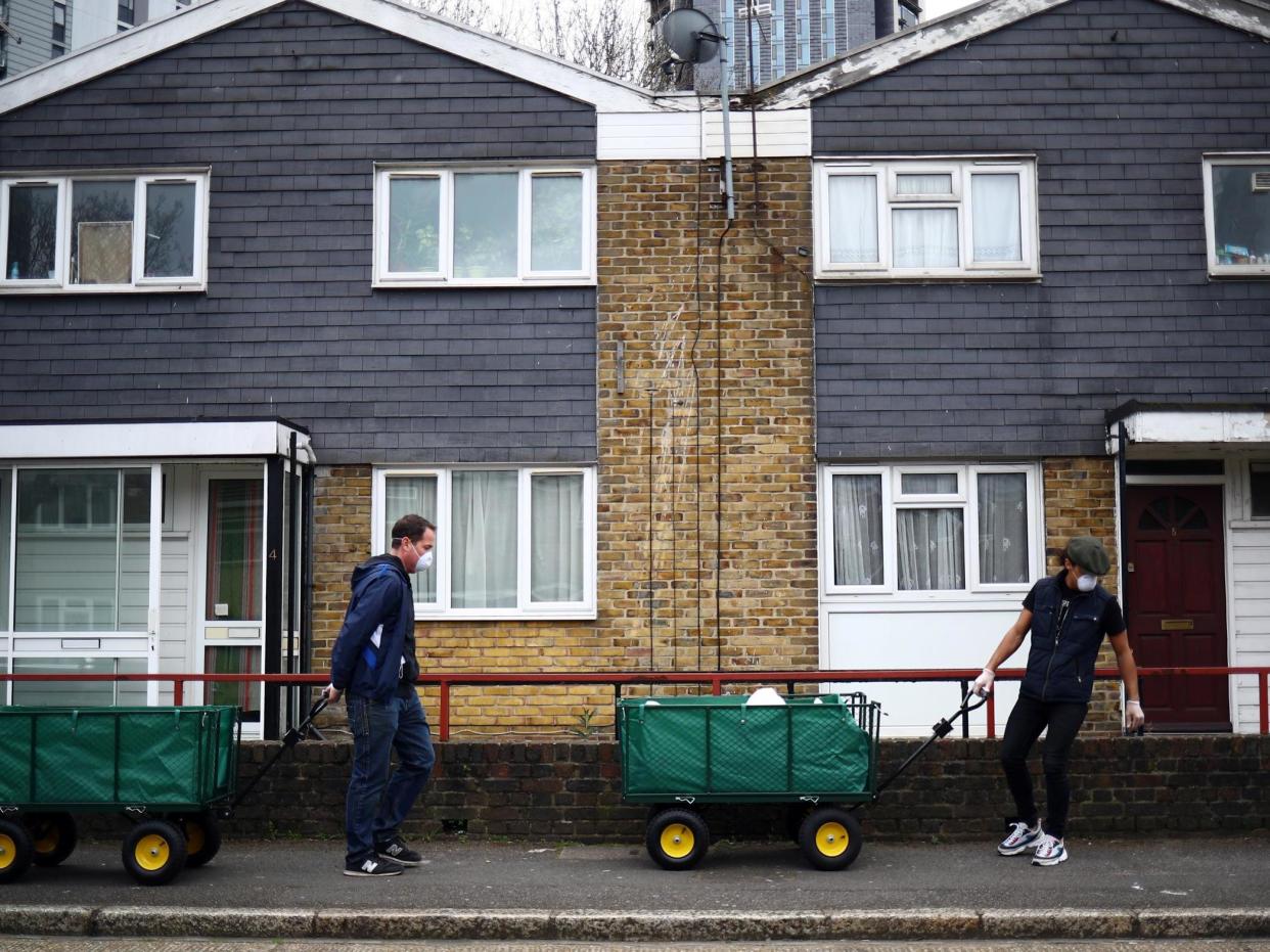 Volunteers drop off donations from a local food bank door-to-door in Stratford: Reuters