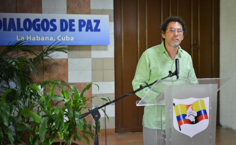 Commander of the FARC-EP leftist guerrilla delegation, Pastor Alape, reads a statement at the Convention Palace in Havana on May 27, 2015