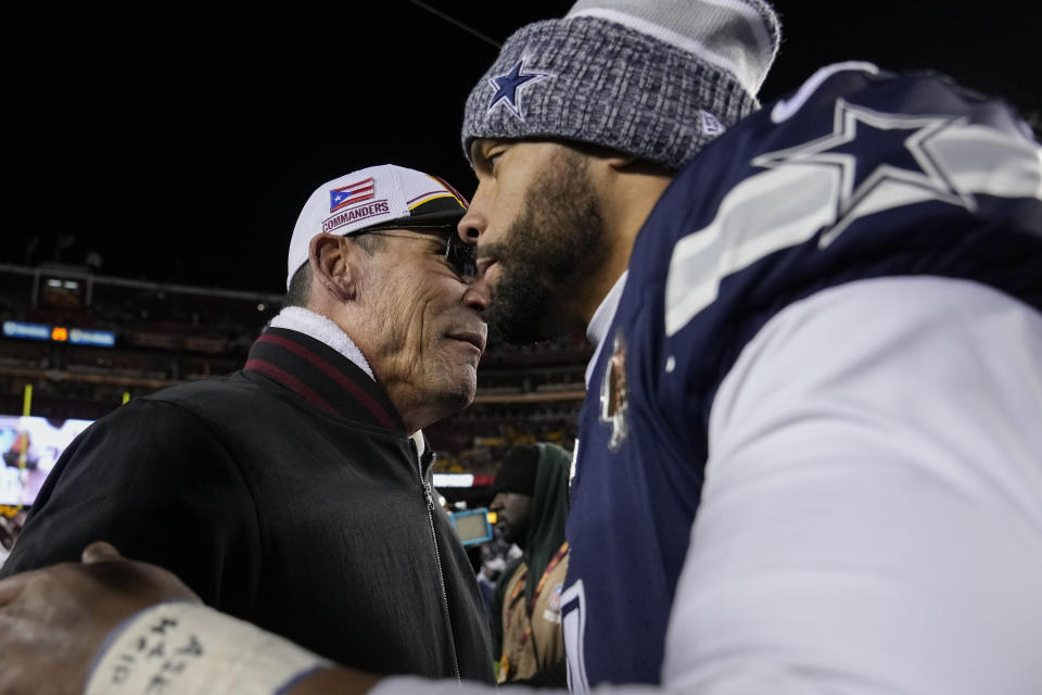 Dallas Cowboys quarterback Dak Prescott (4) and Washington Commanders head coach Ron Rivera, left, embrace at the end of an NFL football game, Sunday, Jan. 7, 2024, in Landover, Md. Dallas won 38-10. (AP Photo/Susan Walsh)