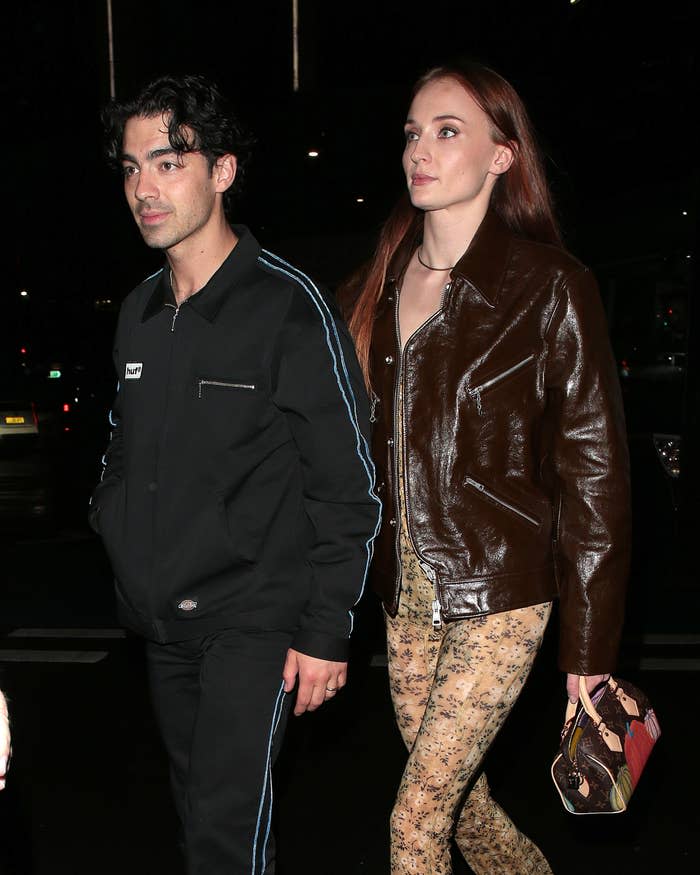 joe and sophie walking somewhere at night