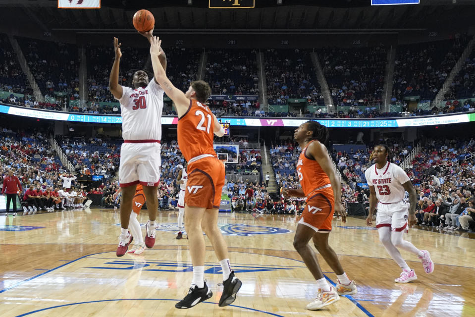 North Carolina State forward D.J. Burns Jr. (30) shoots over Virginia Tech forward Grant Basile (21) during the first half of an NCAA college basketball game at the Atlantic Coast Conference Tournament in Greensboro, N.C., Wednesday, March 8, 2023. (AP Photo/Chuck Burton)