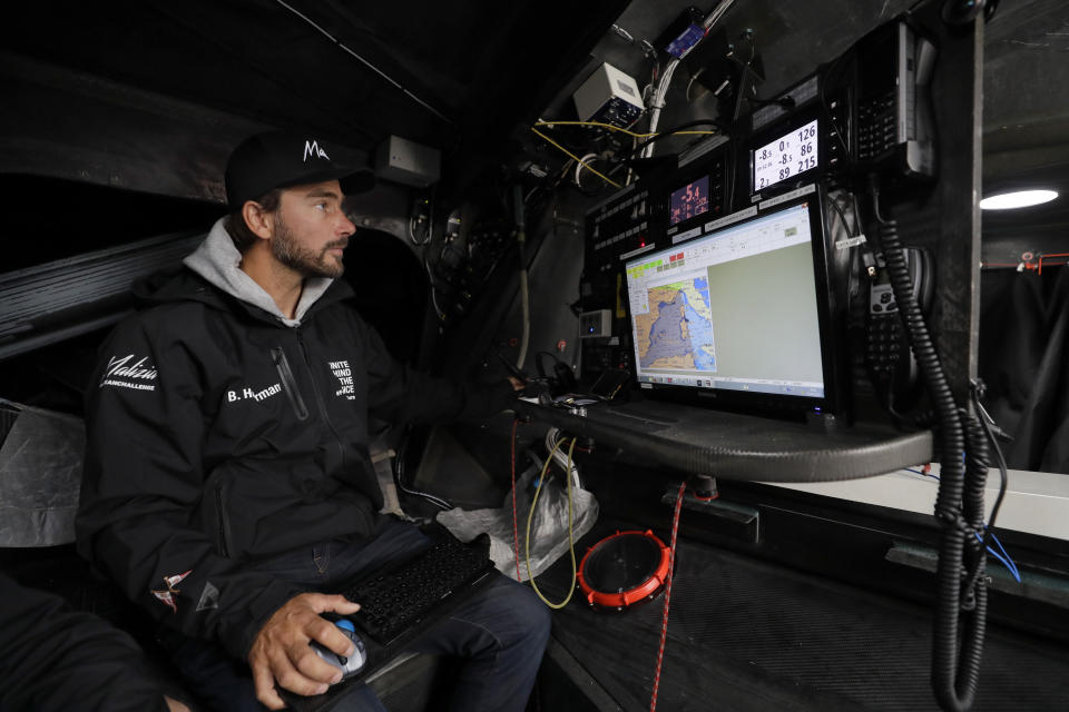 Skipper Boris Herrmann works below deck in the navigation area on the boat Malizia as it is moored in Plymouth, England Tuesday, Aug. 13, 2019. Greta Thunberg, the 16-year-old climate change activist who has inspired student protests around the world, is heading to the United States this week - in a sailboat. (AP Photo/Kirsty Wigglesworth)
