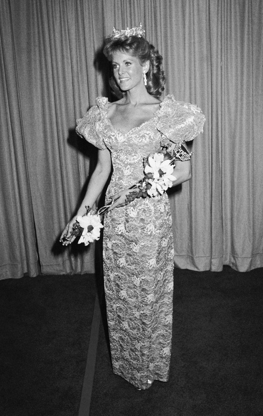 <p>Debra Maffett, 1983 Miss America, stood out in this lacy number. The puff sleeves added just the right amount of drama to the look.</p>