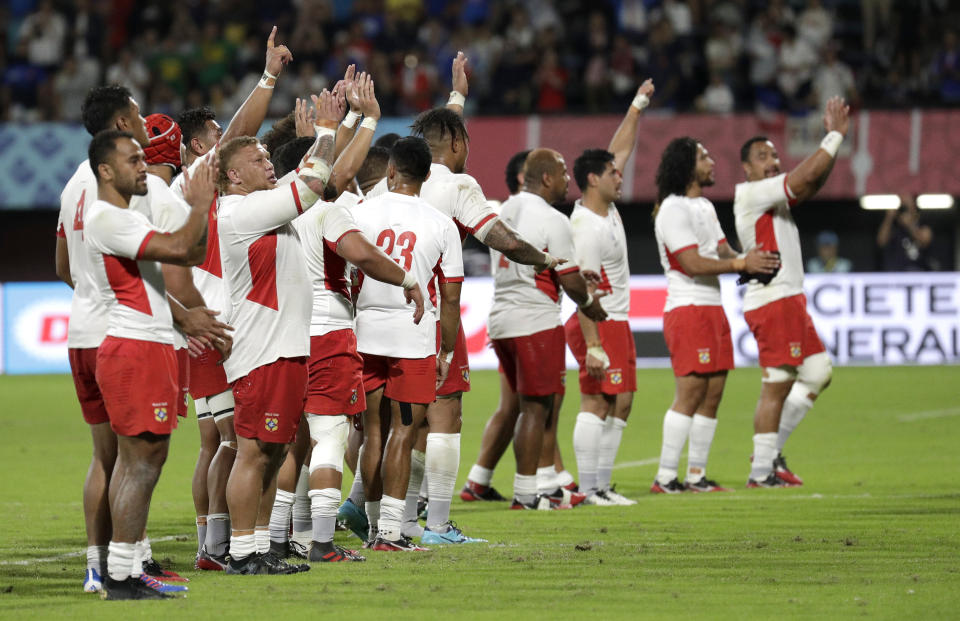 Tongan players wave to the crowd following their Rugby World Cup Pool C game at Kumamoto Stadium against France in Kumamoto, Japan, Sunday, Oct. 6, 2019. (AP Photo/Aaron Favila)