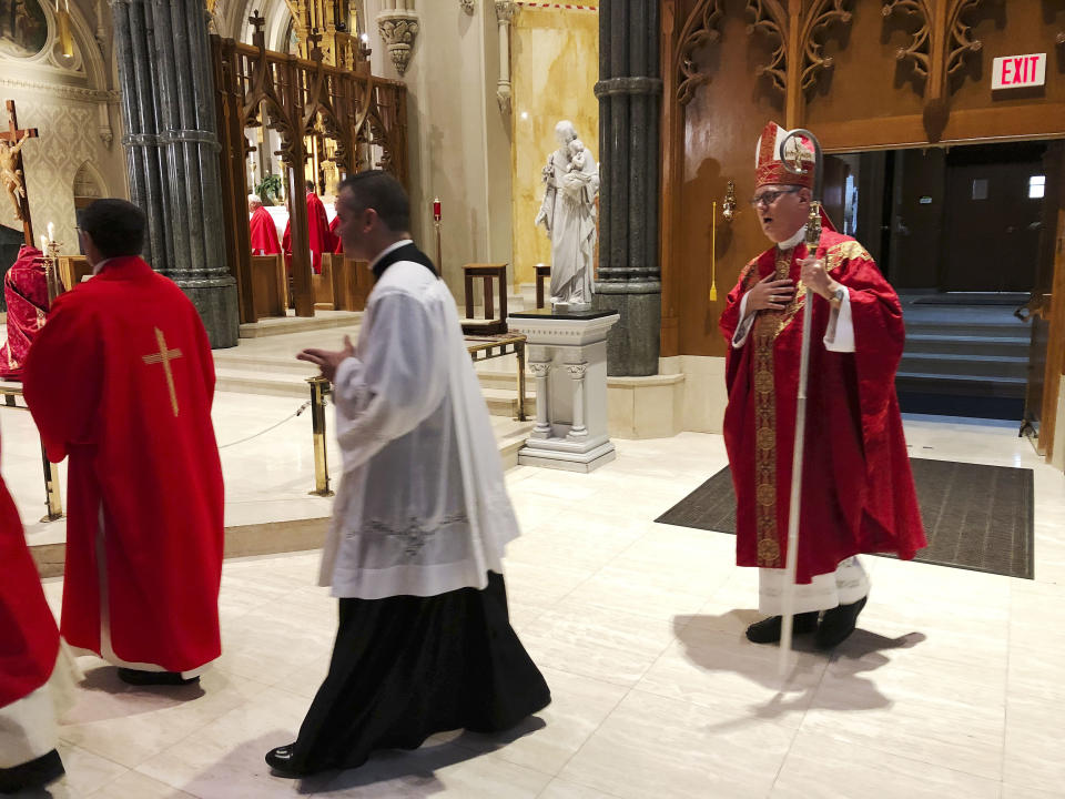 Providence diocese Bishop Thomas Tobin, right, enters the during the processional at the Cathedral of Saints Peter and Paul in Providence, R.I., Friday, Sept. 14, 2018, for a day of prayer and penance he called for due to the sex abuse scandal in the Roman Catholic Church. (AP Photo/Jennifer McDermott)