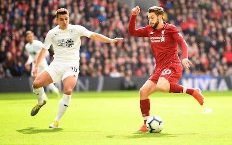 Adam Lallana of Liverpool avoids a challenge from Ashley Westwood of Burnley during the Premier League match between Liverpool FC and Burnley FC at Anfield on March 10, 2019 in Liverpool, United Kingdom - Credit: Getty Images
