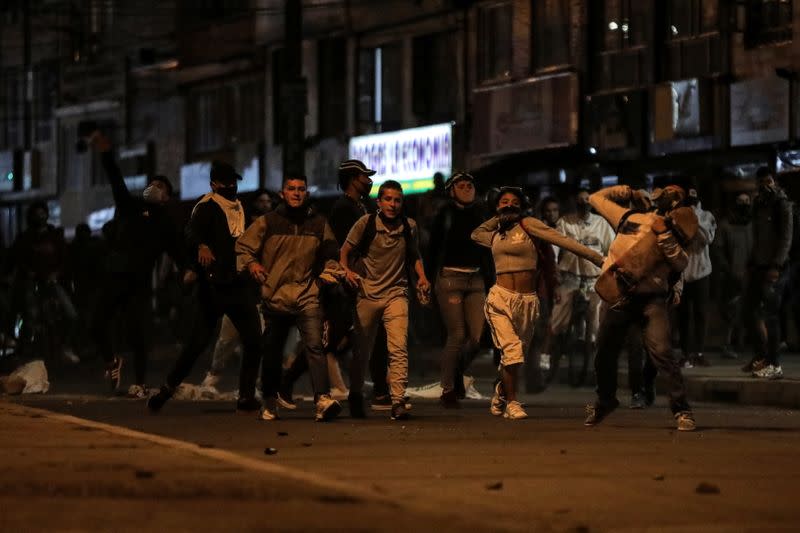 People protest outside a police station after a man, who was detained for violating social distancing rules, died from being repeatedly shocked with a stun gun by officers, according to authorities, in Bogota