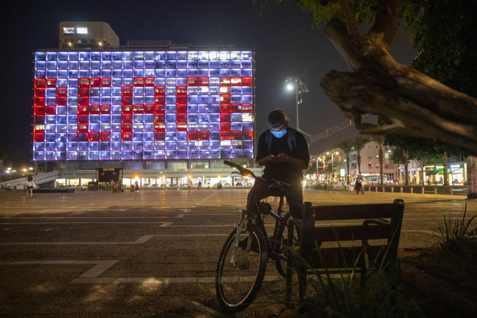 Tel Aviv City Hall is lit up with the words for peace in Hebrew, Arabic and English in honor of the recognition agreements Israel will be signing with the United Arab Emirates and Bahrain at the White House, in Tel Aviv, Israel, Tuesday, Sept. 15, 2020. (AP Photo/Oded Balilty)