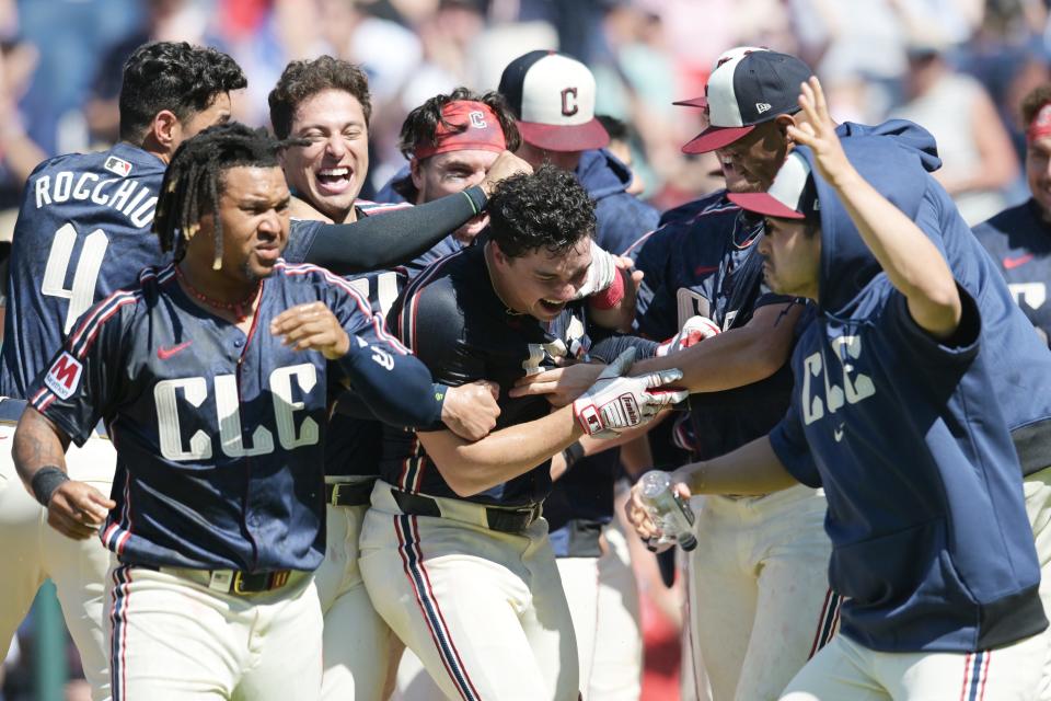 Cleveland Guardians' Will Brennan, middle, celebrates with teammates after hitting a walk-off three-run home run during the ninth inning Sunday against the Minnesota Twins at Progressive Field.