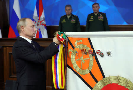 Russian President Vladimir Putin takes part in a ceremony to present the Order of Suvorov to the Eastern Military District during a meeting of Russia's Defence Ministry Board in Moscow, Russia December 18, 2018. Sputnik/Mikhail Klimentyev/Kremlin via REUTERS