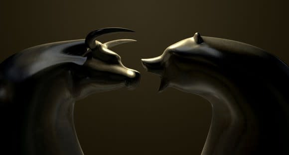 A bull and bear in marble square off in battle.