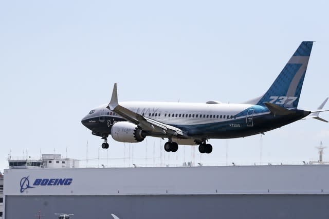 A Boeing 737 Max heads to a landing at Boeing Field in Seattle (Elaine Thompson/PA)